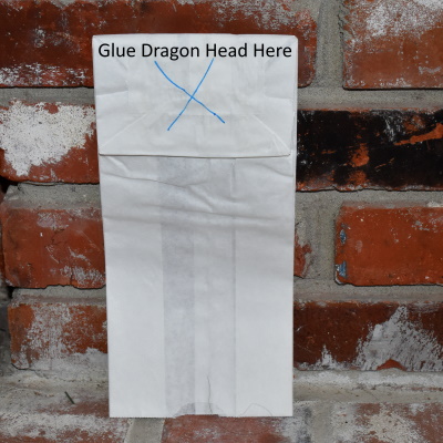 Here is where you glue the dragon head down on the paper bag.
