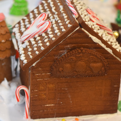 Using wooden molds to make gingerbread decorations for houses.