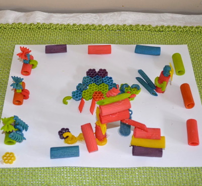 Make this cute 3-e picture, using colored pasta. This is a playground my daughter made.