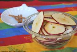 Cutting up apples to make apple chips.