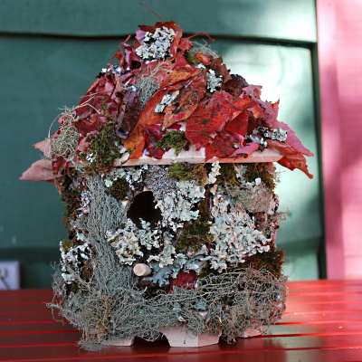 Beautiful birdhouse decorated with nature (leaves, moss)