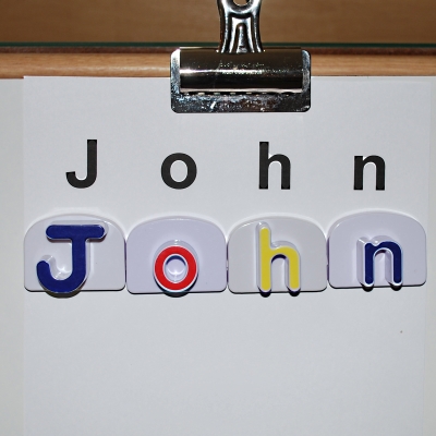 Learning to spell names with magnetic letters.