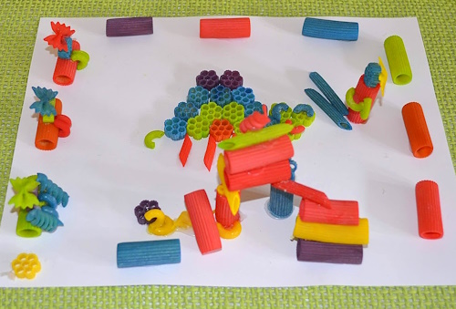 Make this cute 3-e picture, using colored pasta. This is a playground my daughter made.