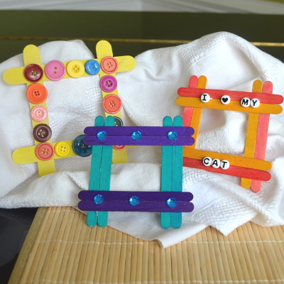 Make a cute frame from colorful popsicle sticks and rhinestone decorations.