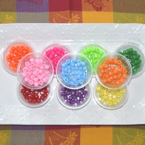 Sorting ponybeads by color.